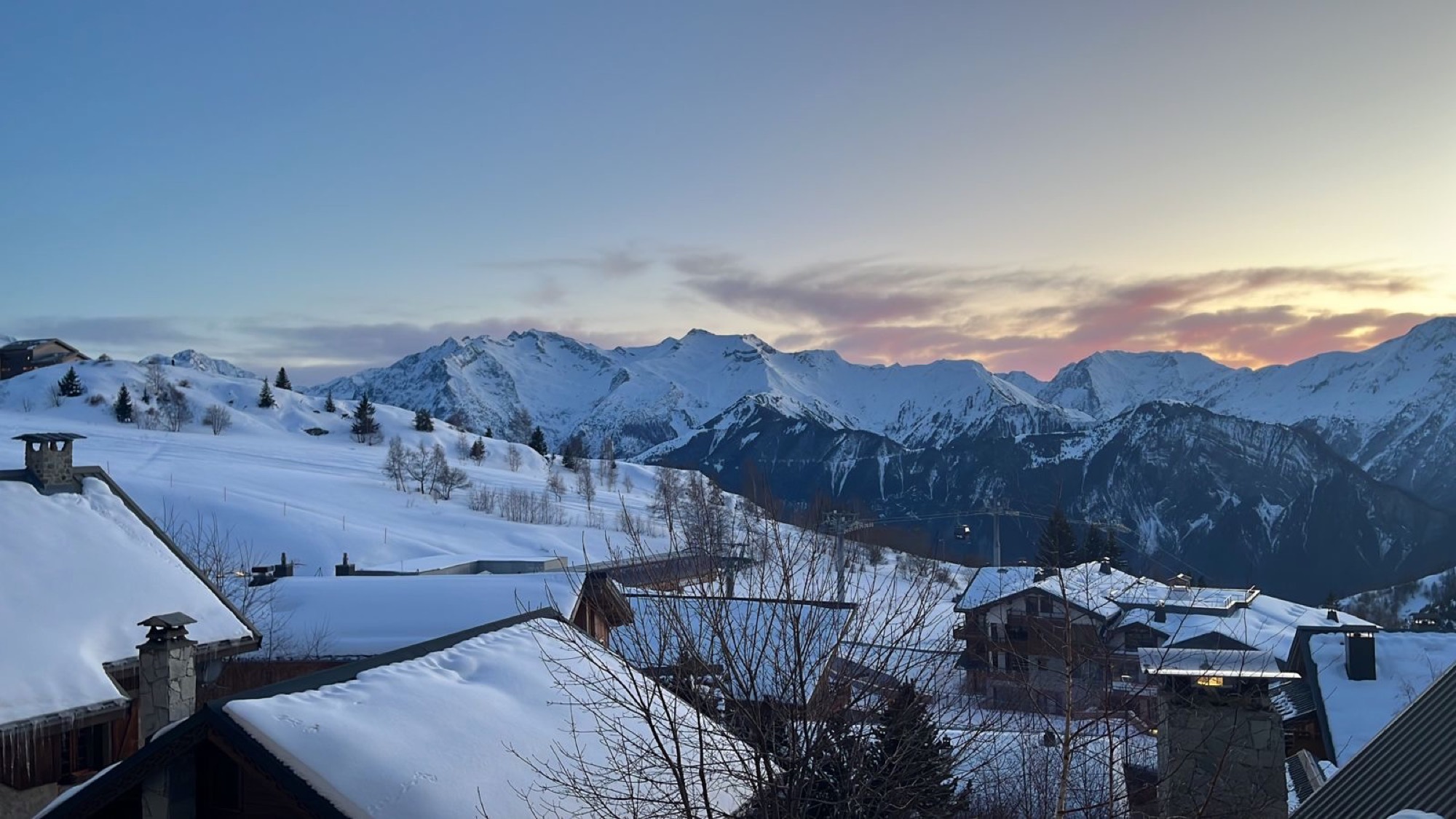A mountain village at dusk, quiet light over the peaks